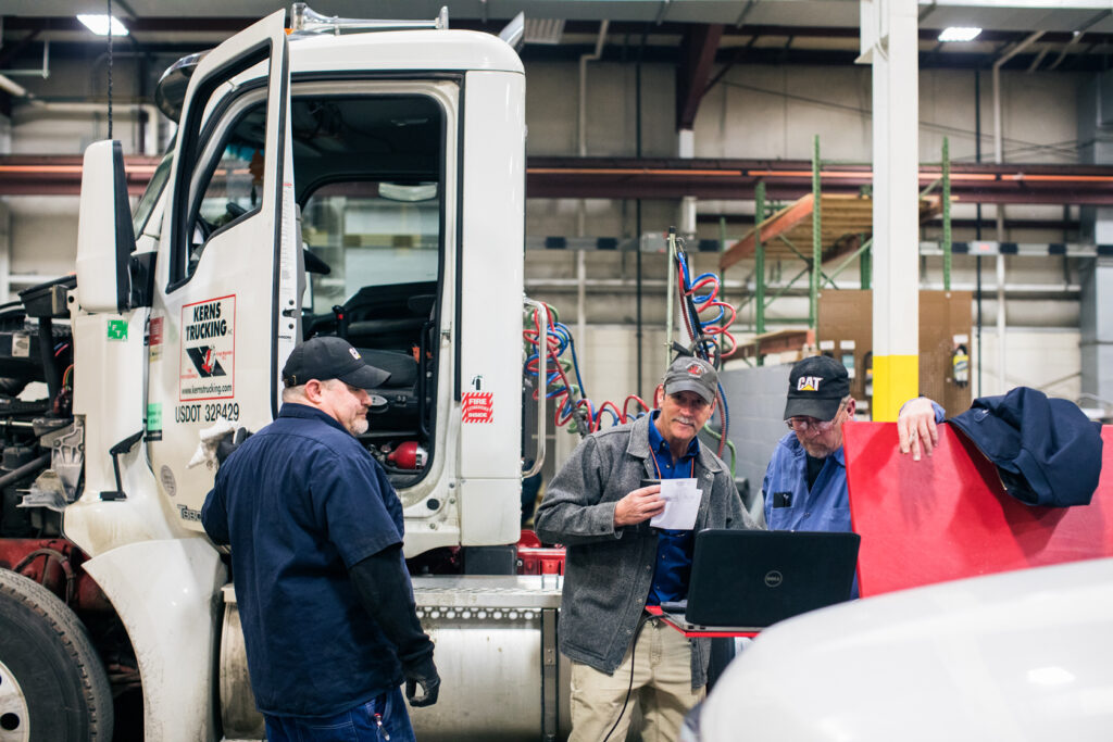 Kerns trucking maintance personel perform service prepping a Semi Truck for deployment.